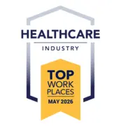 Award badge: Healthcare Industry Top Workplaces May 2026, featuring a yellow ribbon/banner with dark blue text and a blue framed arch motif.