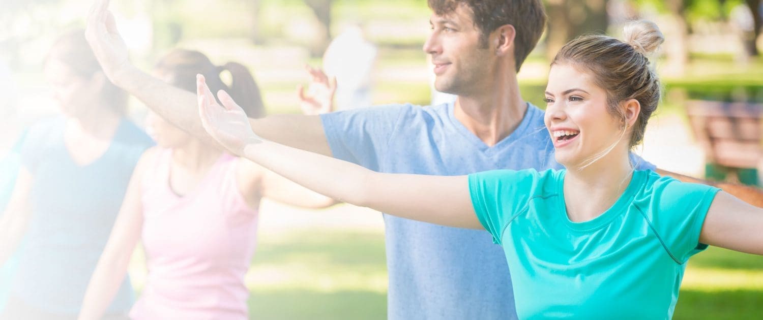 Group of people practicing yoga outside