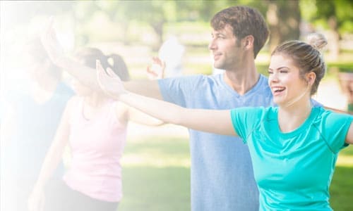 Group of people practicing yoga outside