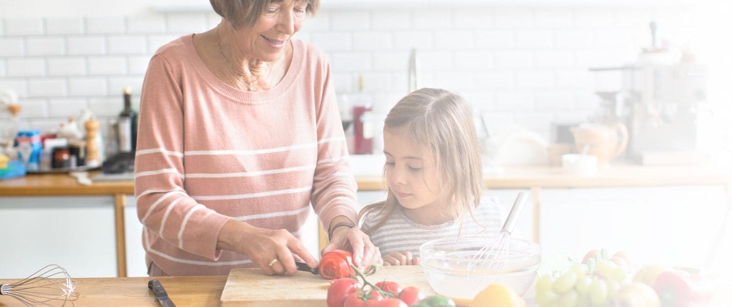 Grandmother teaching granddaughter to cook