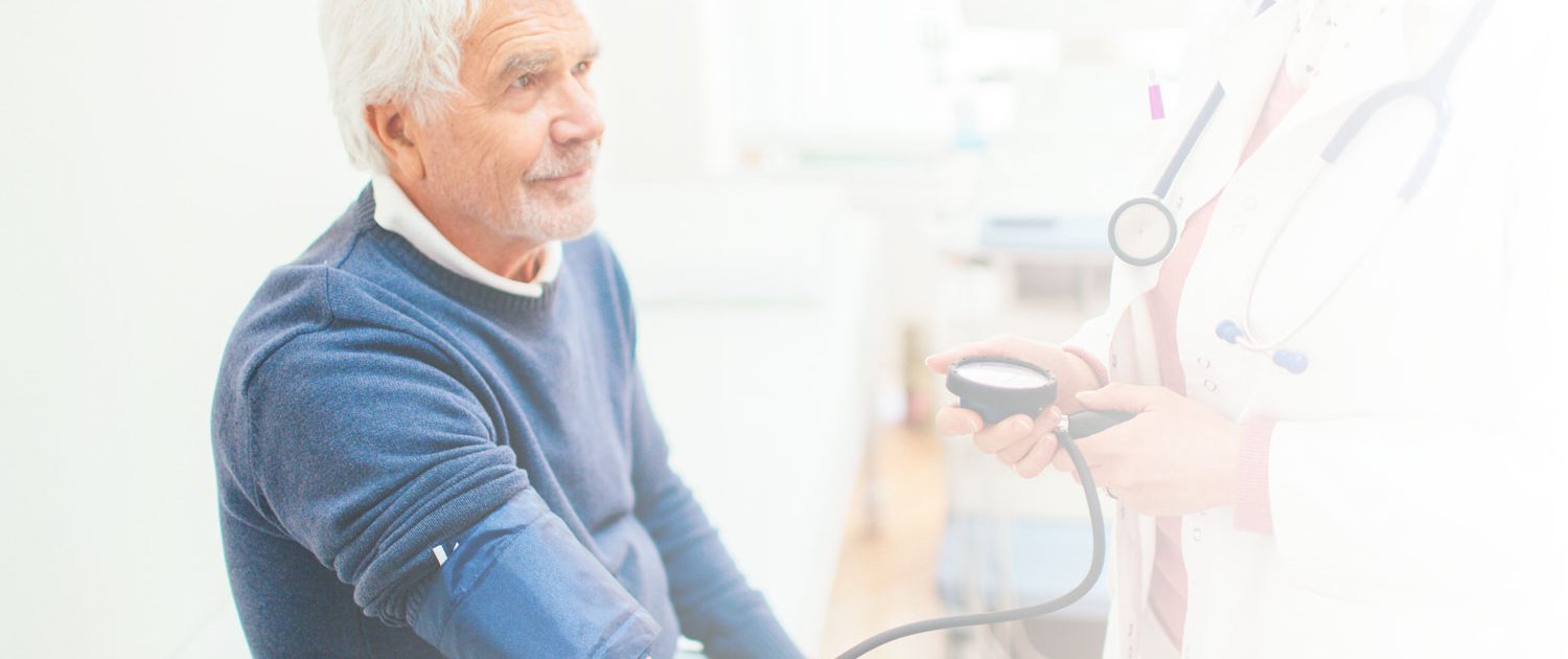 Elderly man getting blood pressure checked