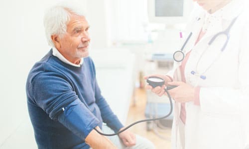 Elderly man getting blood pressure checked