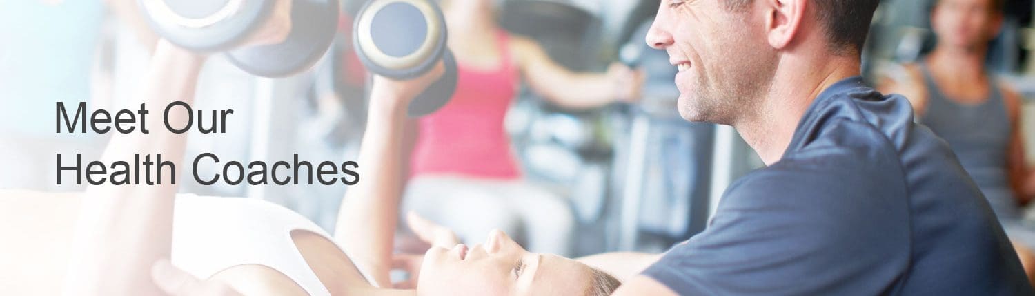 Health coach helping young woman bench press