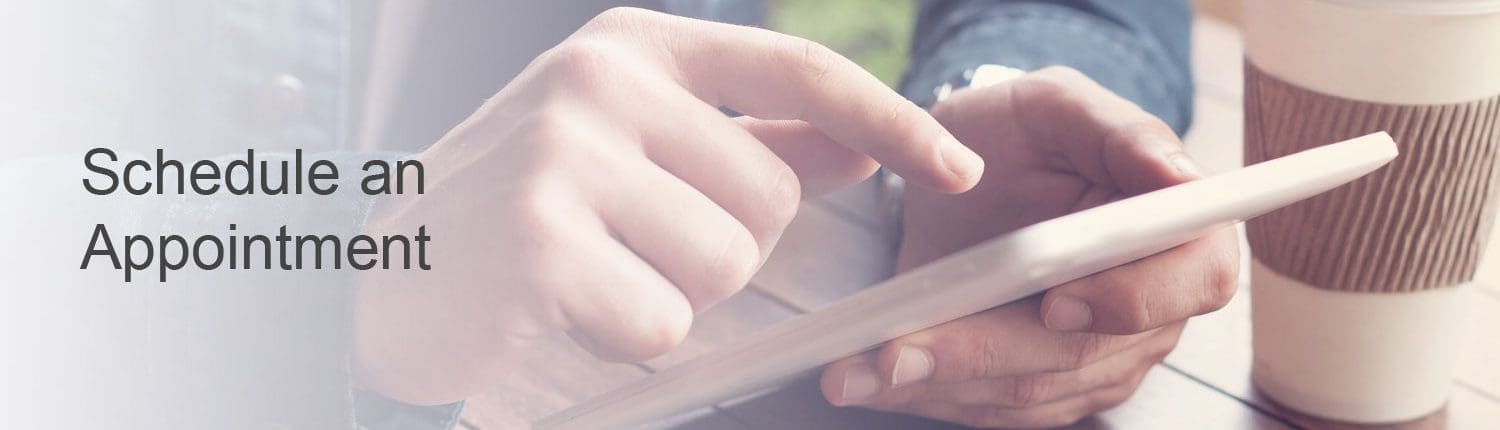 Man using iPad to schedule appointment with doctor