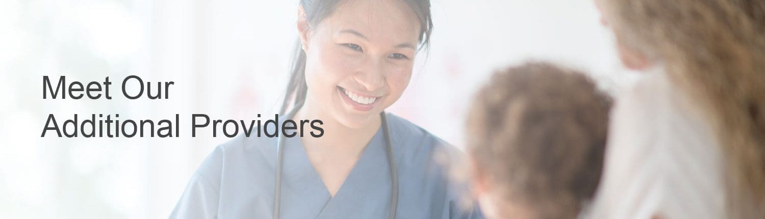 Hospital employee smiling at young girl and mother