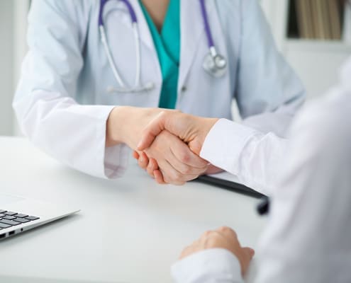 Physician and patient shaking hands