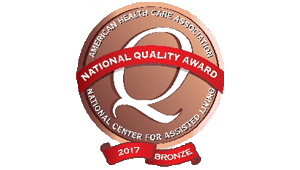 Bronze National Quality Award badge (2017) from the American Health Care Association/National Center for Assisted Living with a red ribbon and center emblem.