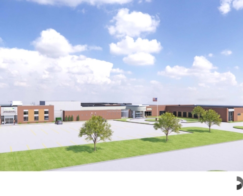 Wide view of a modern commercial complex with brick and white storefronts, a large parking lot, and landscaped trees under a bright blue sky with scattered clouds, plus an American flag on a pole; Davis Design watermark bottom right.