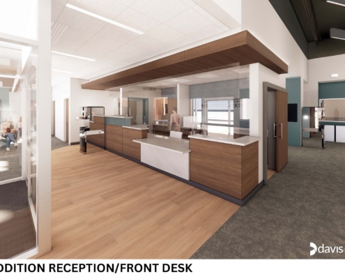 Wide view of a modern office reception area featuring a wood-front desk, glass partitions, and a seating/lobby area in the background.