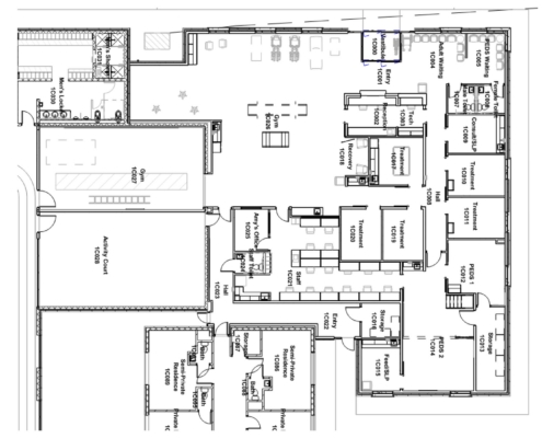 Detailed floor plan of a medical facility showing gym, recovery, treatment areas, staff offices, storage, and waiting areas with labeled rooms and corridors.